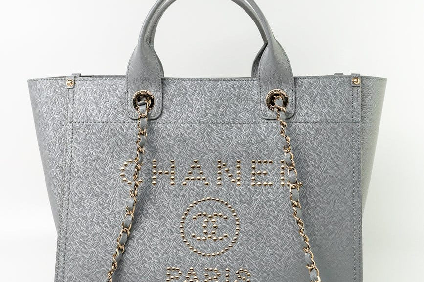 CHANEL Tote Grey Caviar Studded Deauville Tote Light Gold Hardware - Redeluxe